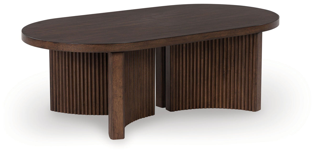 Korestone - Oval Cocktail Table - Dark Brown by Ashley – Coffee Tables