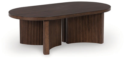Korestone - Oval Cocktail Table - Dark Brown by Ashley – Coffee Tables